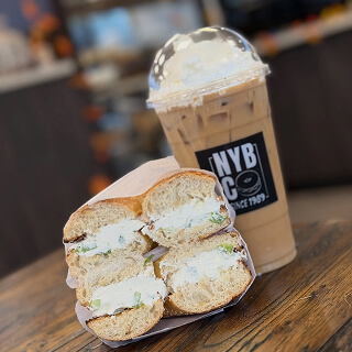Breakfast sandwich halves with an NYBC iced coffee