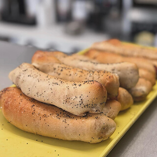 Fresh poppy seed bagels on a tray